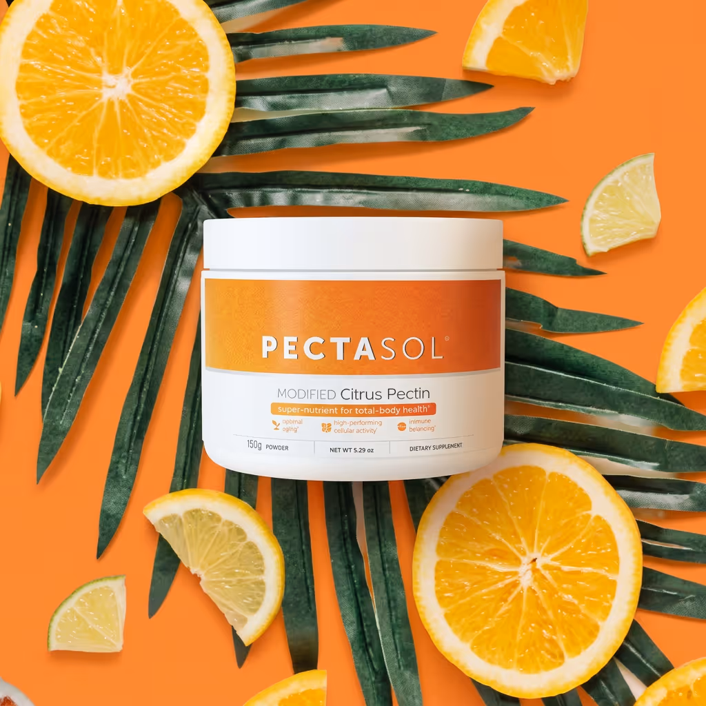 Container of PECTASOL Modified Citrus Pectin dietary supplement surrounded by green palm leaves and orange and lemon slices on an orange background.