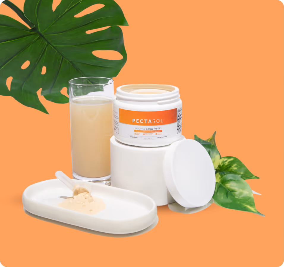 Open container of Pectasol citrus pectin powder with a glass of mixed drink, a spoon of powder on a dish, and green leaves on an orange background.
