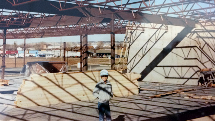 Steve T. Langlas as a child on a Langlas jobsite inside a steel-framed building, circa 1983