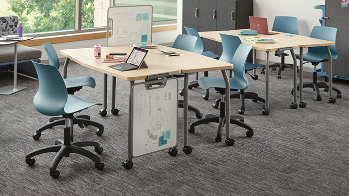 Multi-purpose office tables with mobile chairs and writable panels in a flexible collaborative workspace