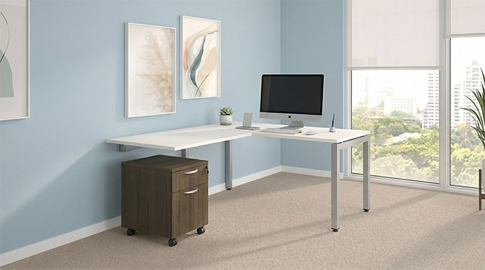 Mobile pedestal storage unit with drawers under a desk in a modern office workspace