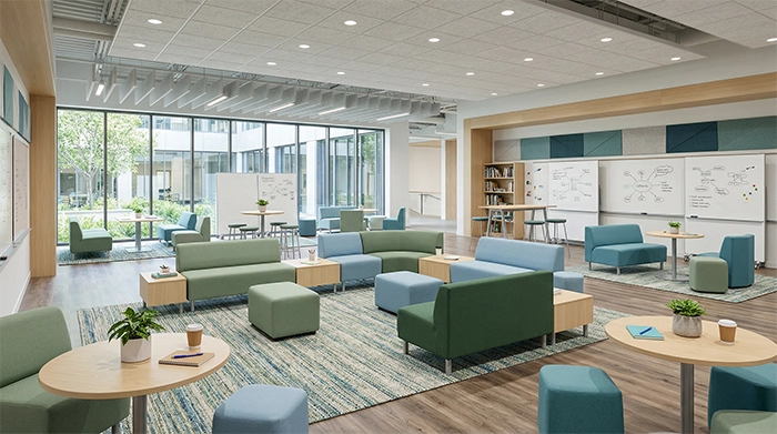 Modular lounge seating system with flexible upholstered pieces arranged for collaboration in a modern office space