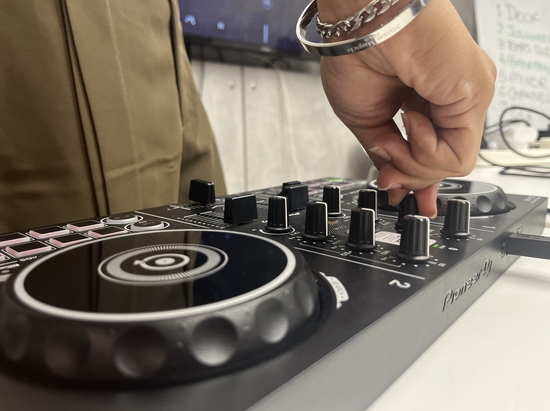 A DJ mixing at a Hustle class
