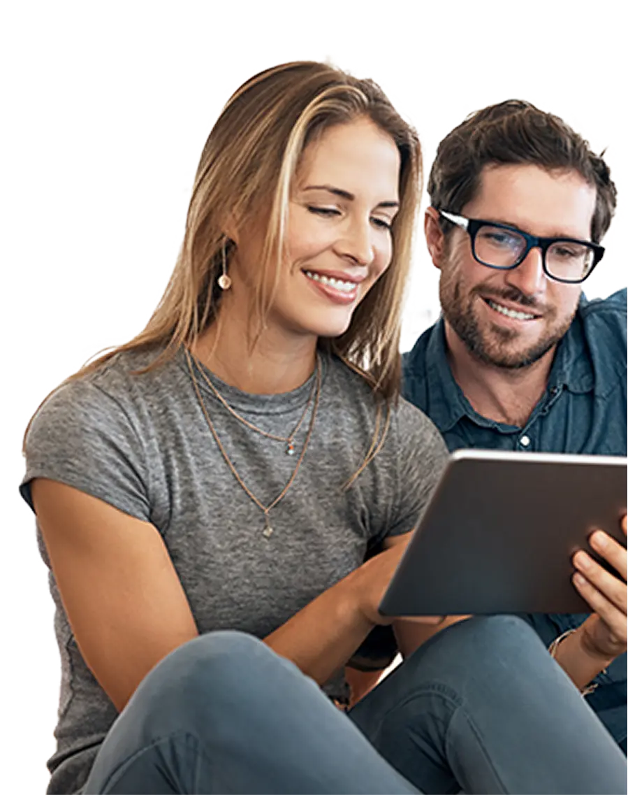 Smiling man with glasses and woman looking at a tablet together.