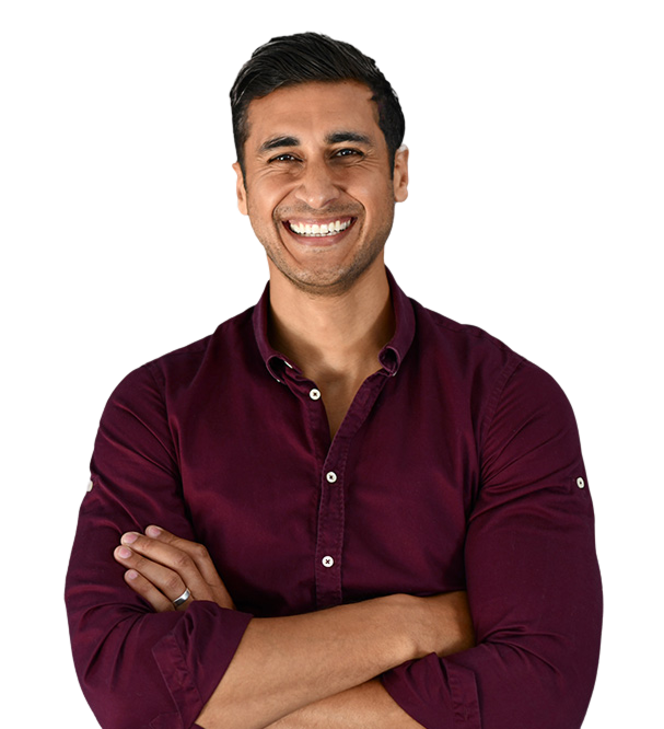 Smiling man with folded arms wearing a maroon button-up shirt.