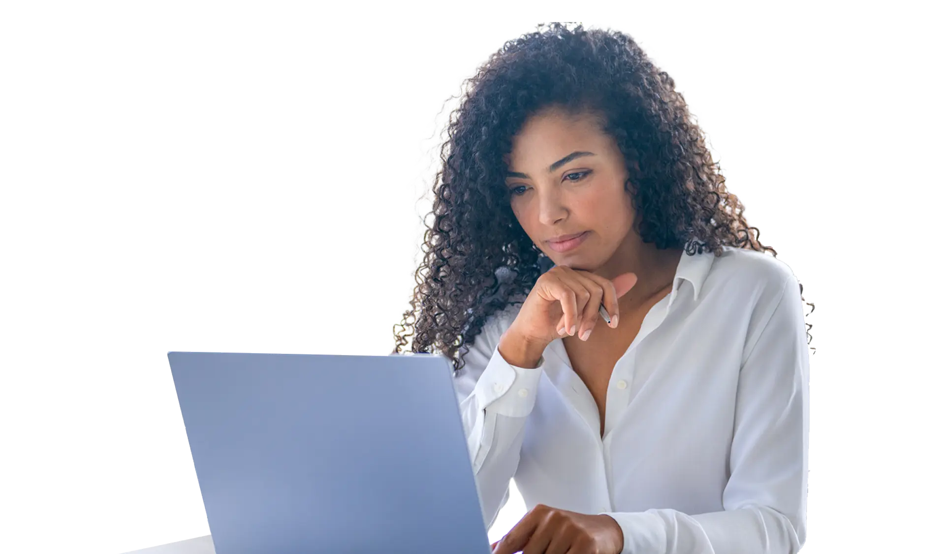 Thoughtful woman with curly hair in a white shirt working on a laptop.