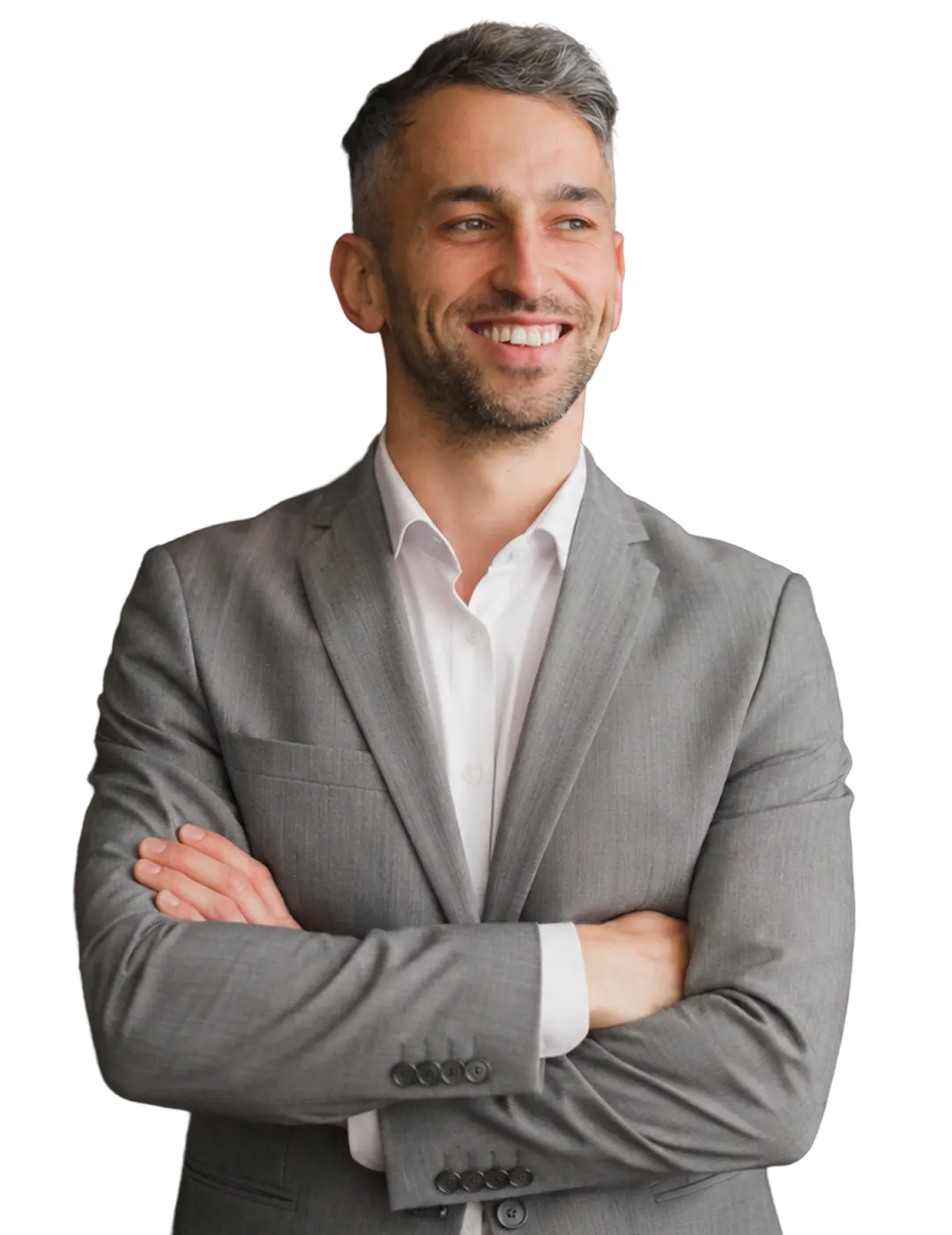 Smiling man in a gray suit jacket with arms crossed looking off to the side