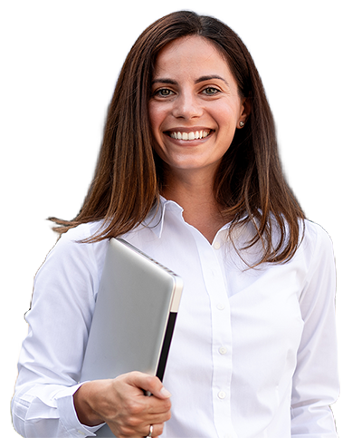 Smiling businesswoman in white shirt holding a silver laptop against a blurred background.