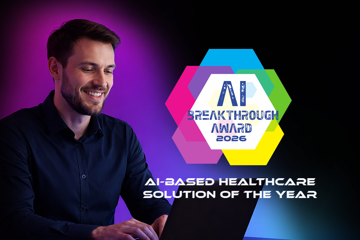 Man smiling, holding laptop, beside AI Breakthrough Award for AI-based Healthcare Solution of the Year.