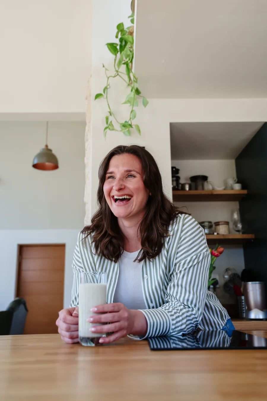 Happy client enjoying a drink at home during a Content Sprint shoot