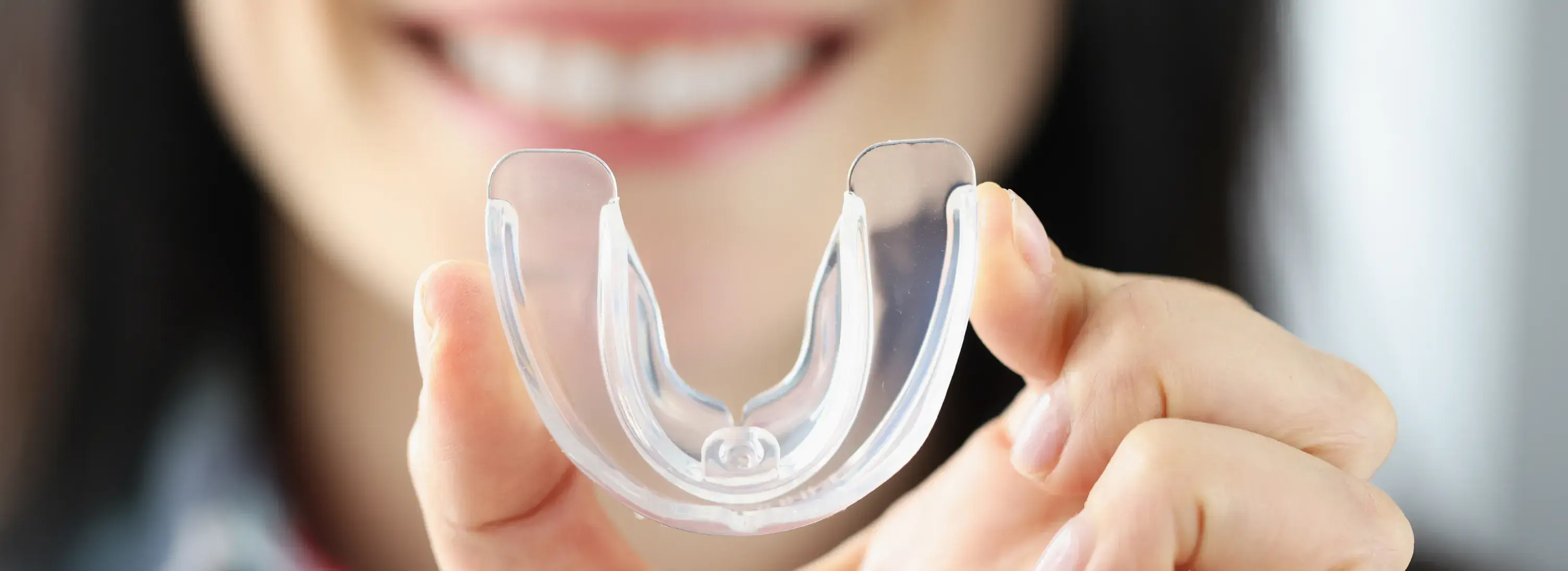 A close up of a person holding a plastic object.