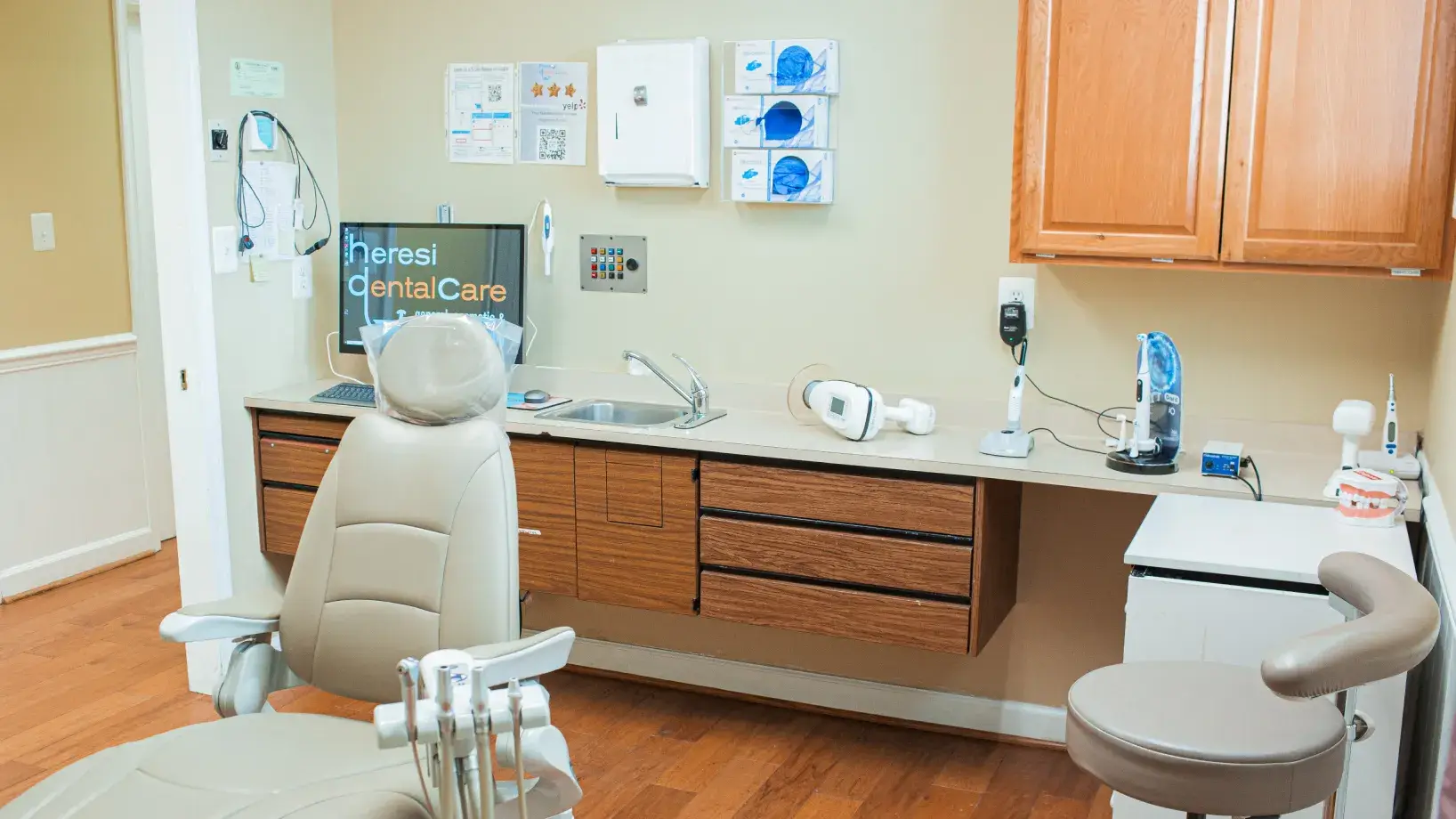A dental office with a sink and chair.