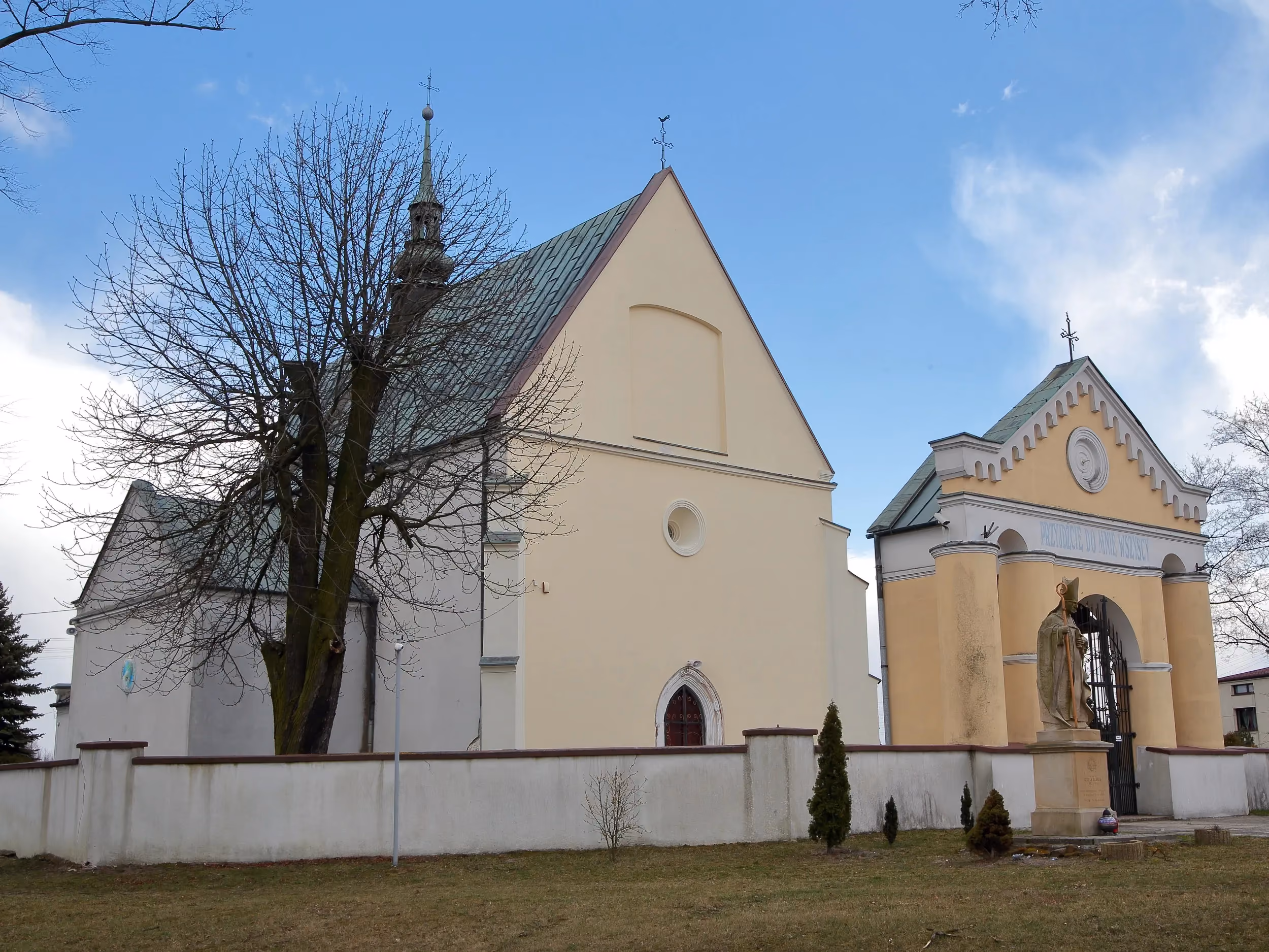 Kościół pw. św. Marcina w Kodrębie z frontową bramą i figurą świętego, widziany pod kątem od strony południowej.