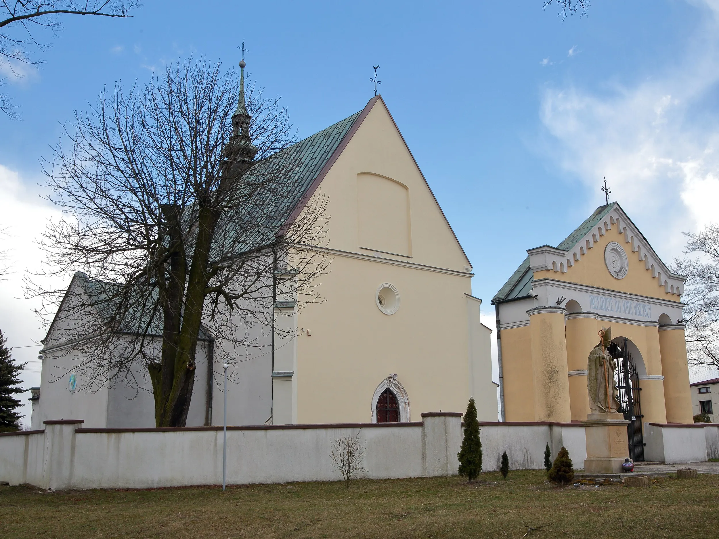 Kościół pw. św. Marcina w Kodrębie z frontową bramą i figurą świętego, widziany pod kątem od strony południowej.