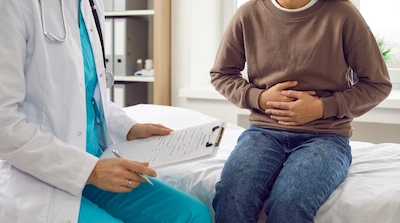 Boy sitting next to doctor
