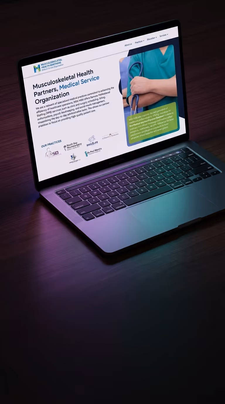Laptop on a dark wooden surface displaying a musculoskeletal health organization's website featuring a healthcare professional with folded arms and stethoscope.