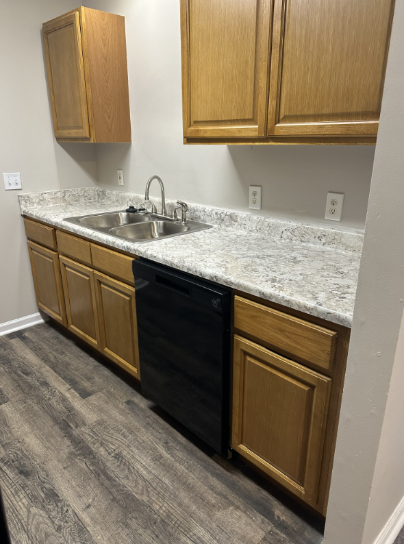 Kitchen with brown wood cabinets and black appliances