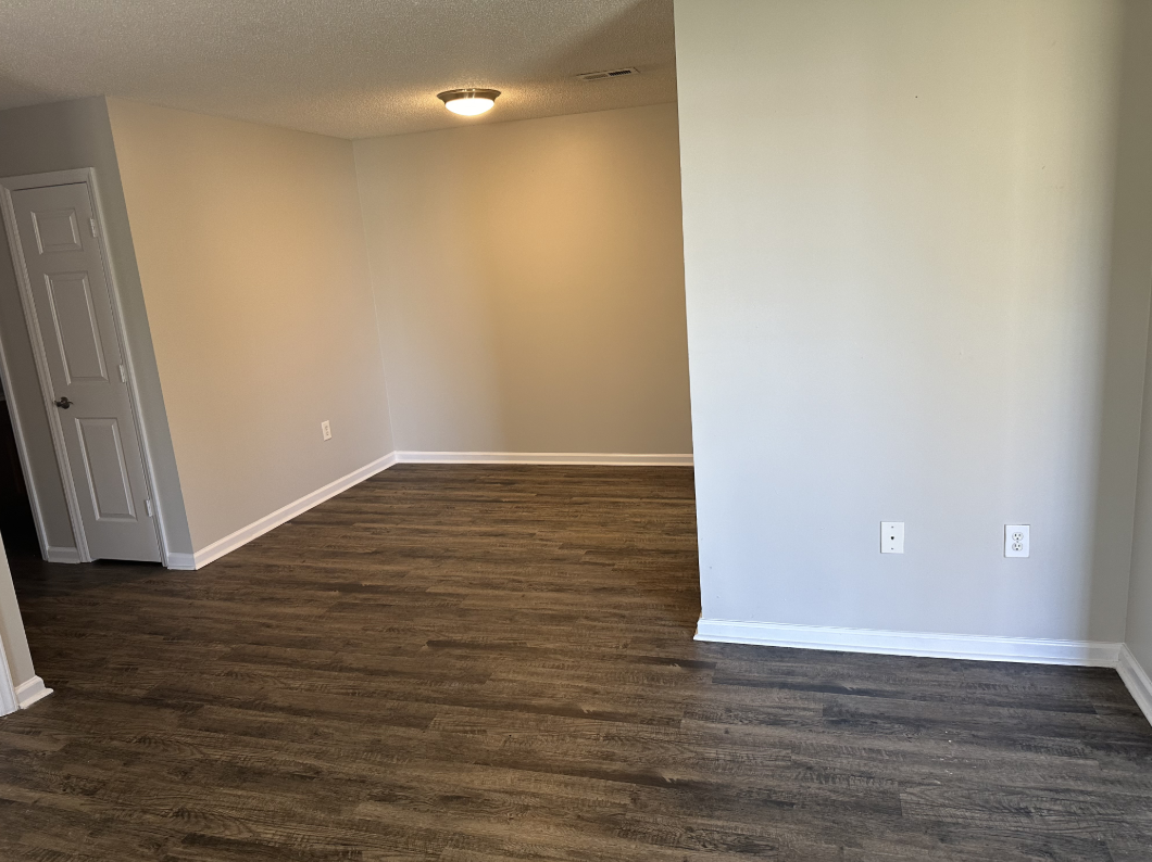 Dining area unfurnished with wood floors