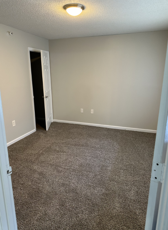 Unfurnished bedroom with carpet
