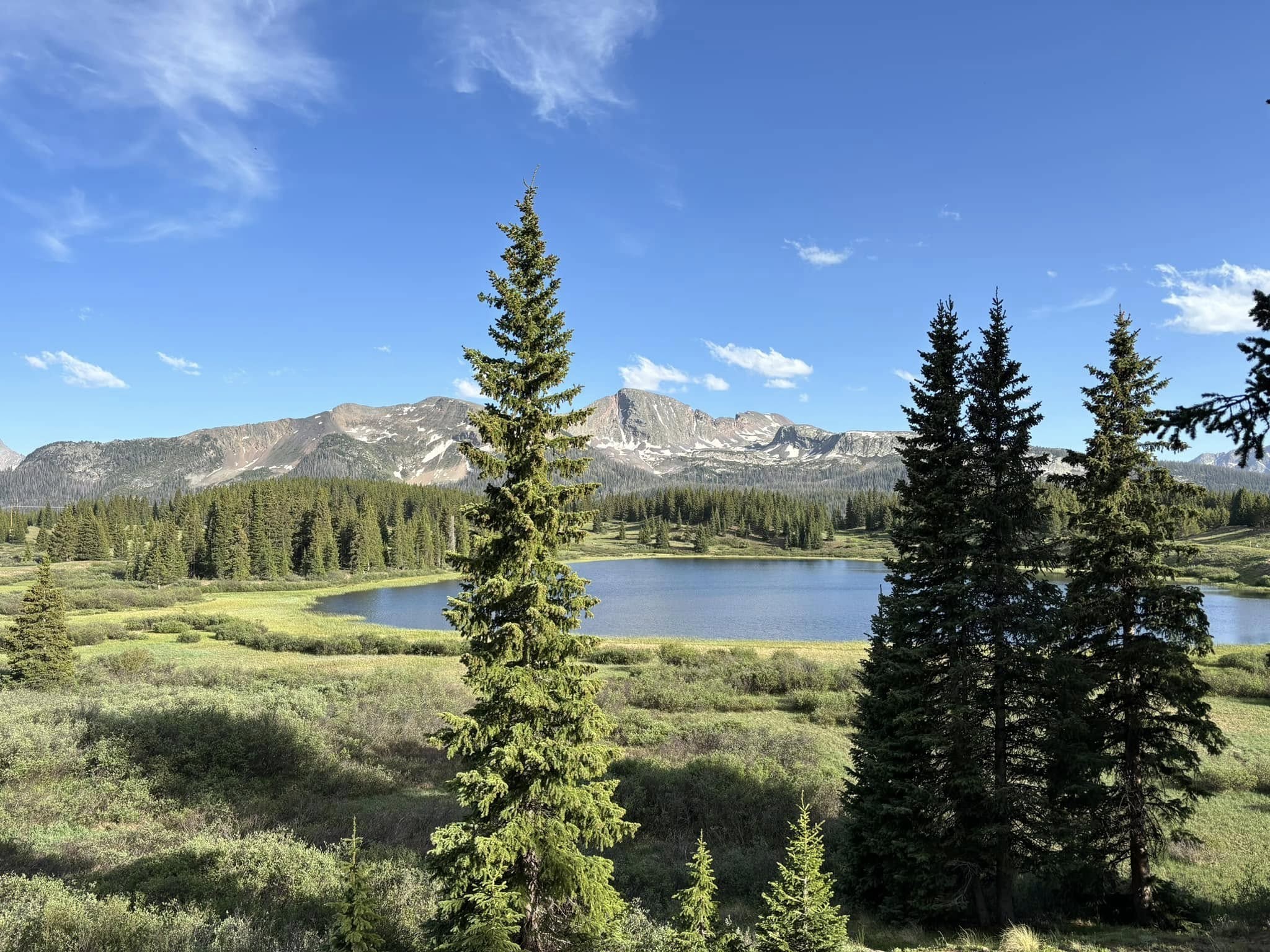 A lake with mountains behind.
