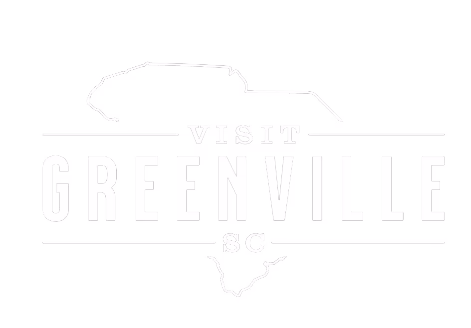 Visit Greenville, SC logo, white against transparent background.
