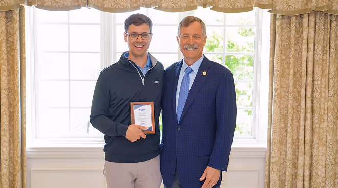 MAU leader presenting an award to a team member — recognizing excellence and the importance of people