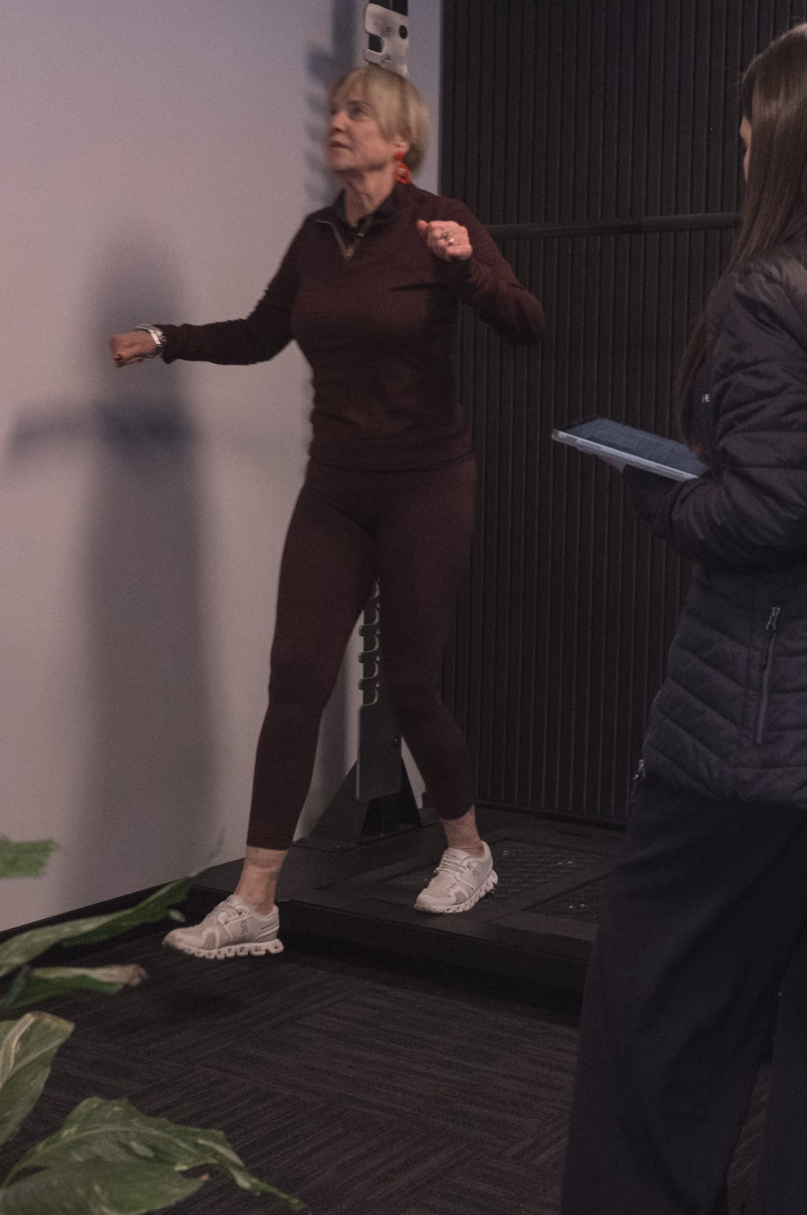 Client stepping off a treadmill while the EP records on a tablet