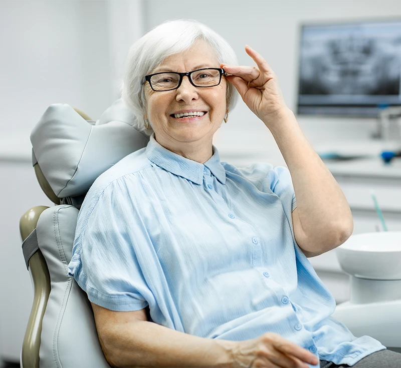 A woman sitting in a dentist chair.