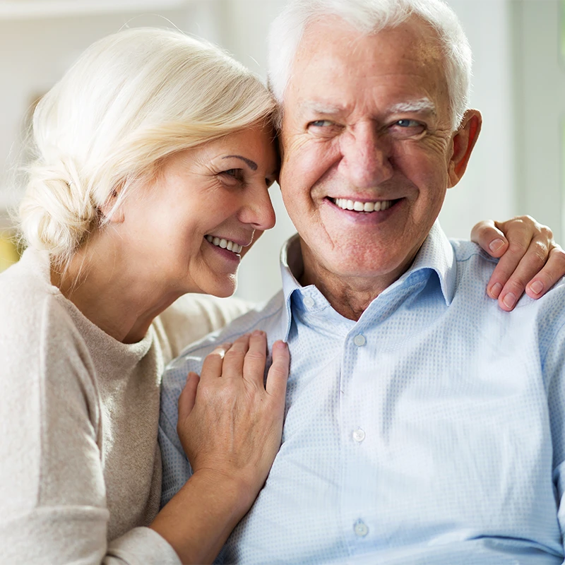 An older man and woman smiling.