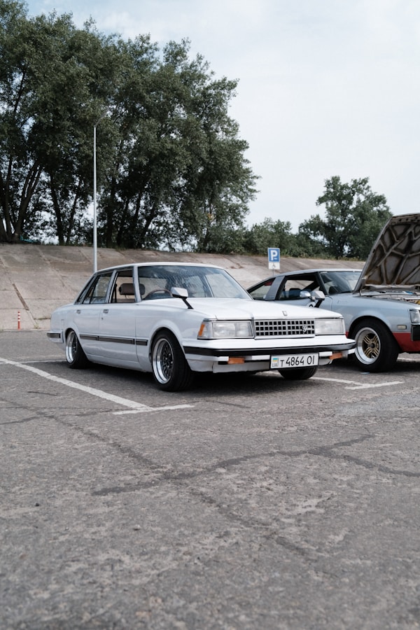 a white car parked next to a black car