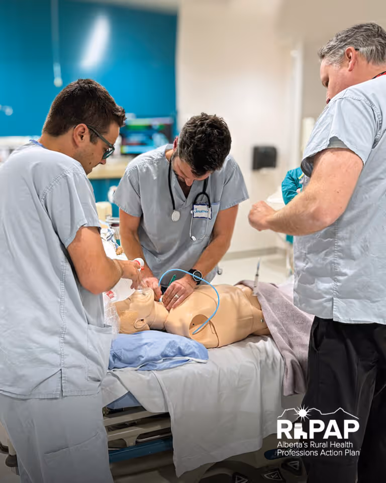Three healthcare workers practicing CPR on a medical training mannequin in a clinical setting.