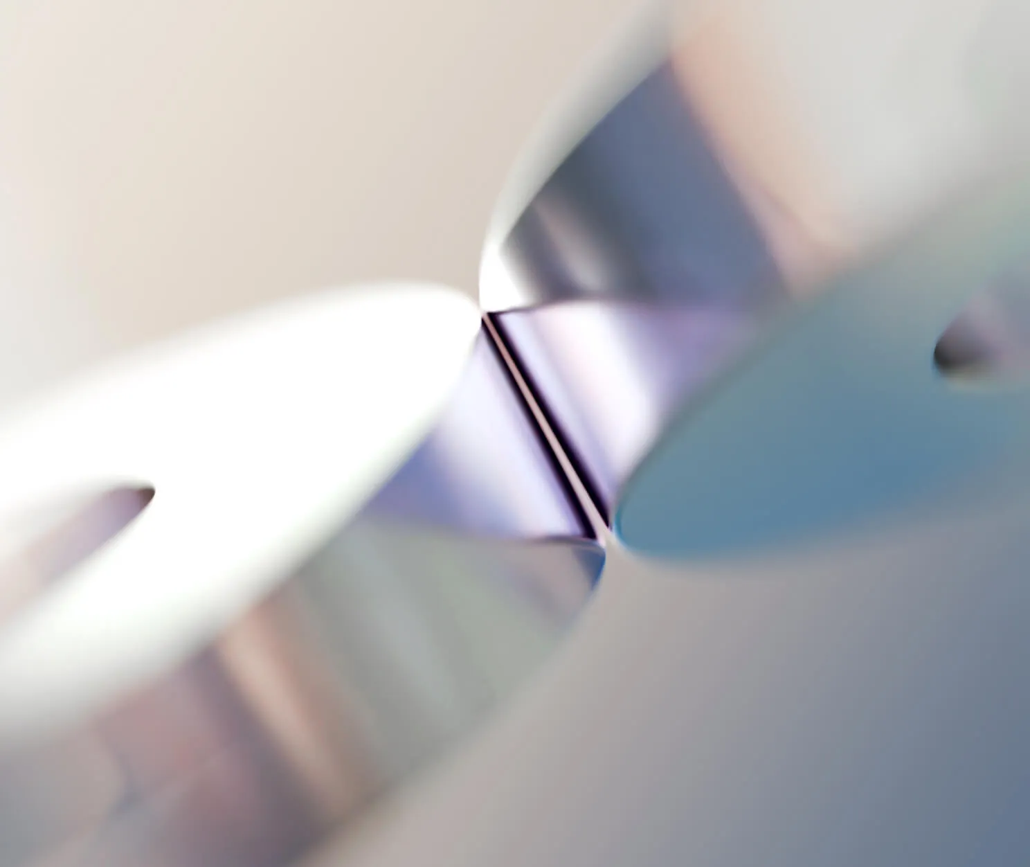 Close-up of a metallic cylindrical object with reflective surfaces and soft lighting.