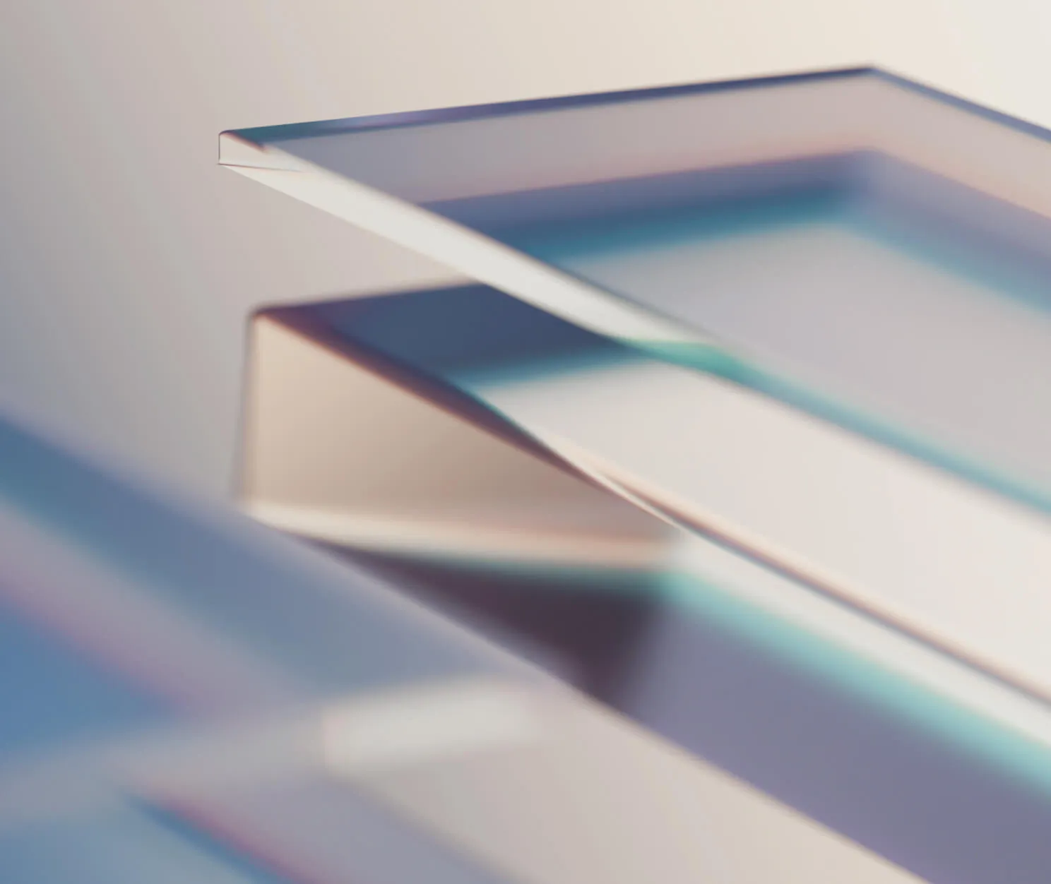 Close-up of several transparent, slightly curved glass or acrylic sheets stacked and overlapping.