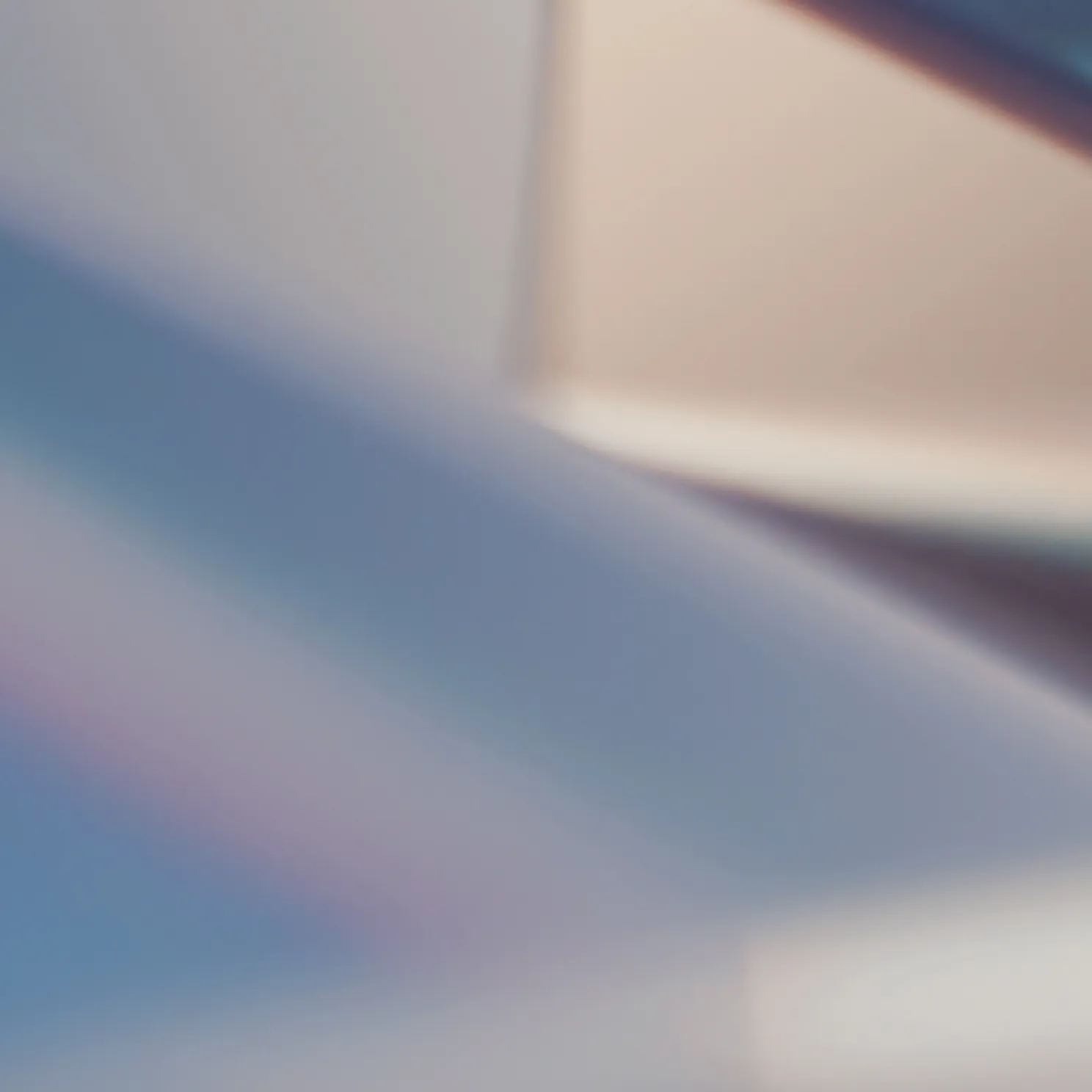 Abstract blurred background with soft, overlapping shades of blue, beige, and purple.