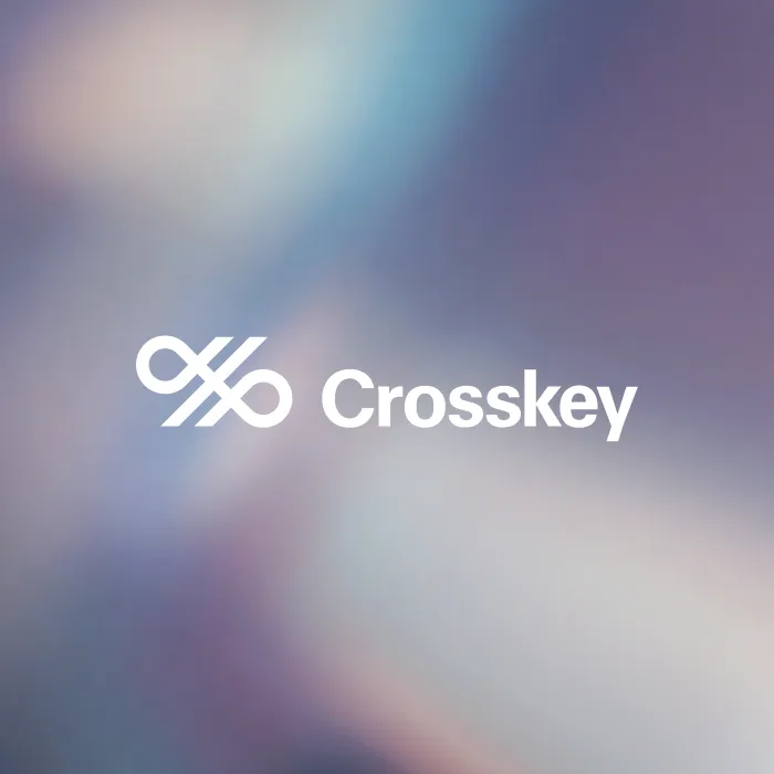 Crosskey company logo with an abstract design symbol on a blurred blue and purple background.