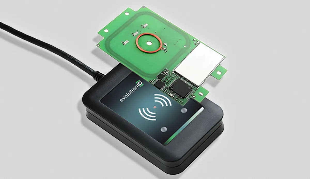 Black RFID reader device with a green circuit board partially positioned above it.