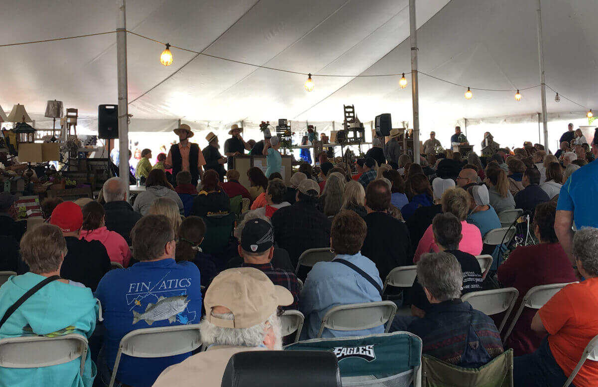 Crowd under a tent at an Amish Mud Sale at the Markets at Shrewsbury in Glen Rock, PA|Tim Paone|Spring auction|Join us at the 20th Annual Spring Auction to bid on furniture, handcrafts, decor, lawn furniture, and more!|Spring Auction|2025 spring auction event schedule