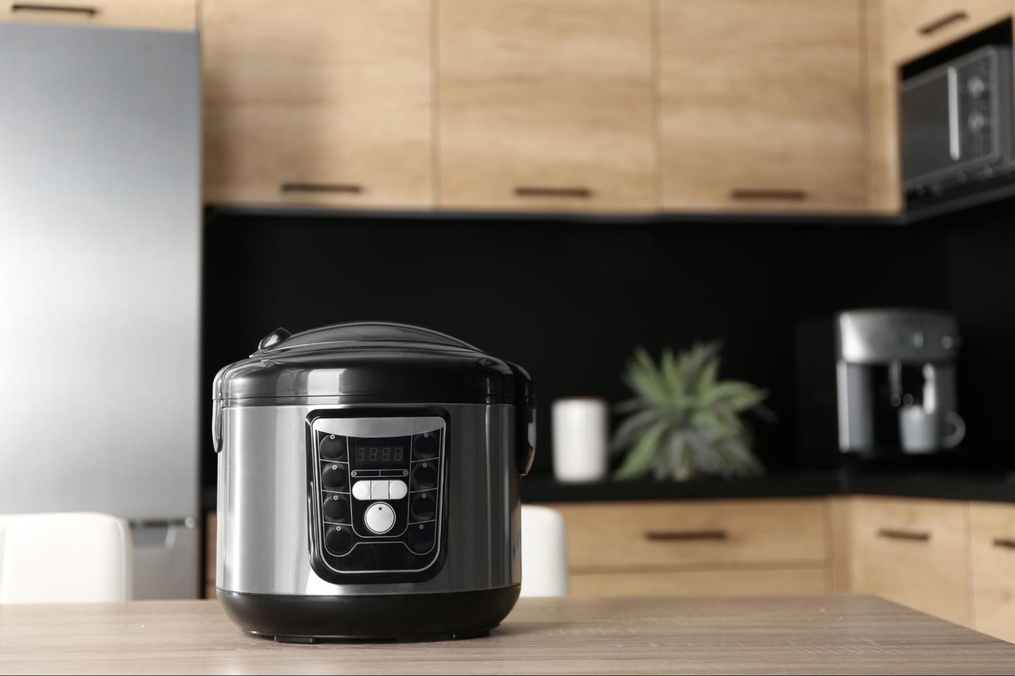 Black and Silver Crockpot Filled With Slow Cooker Pulled Pork Sitting on Modern Kitchen Counter
