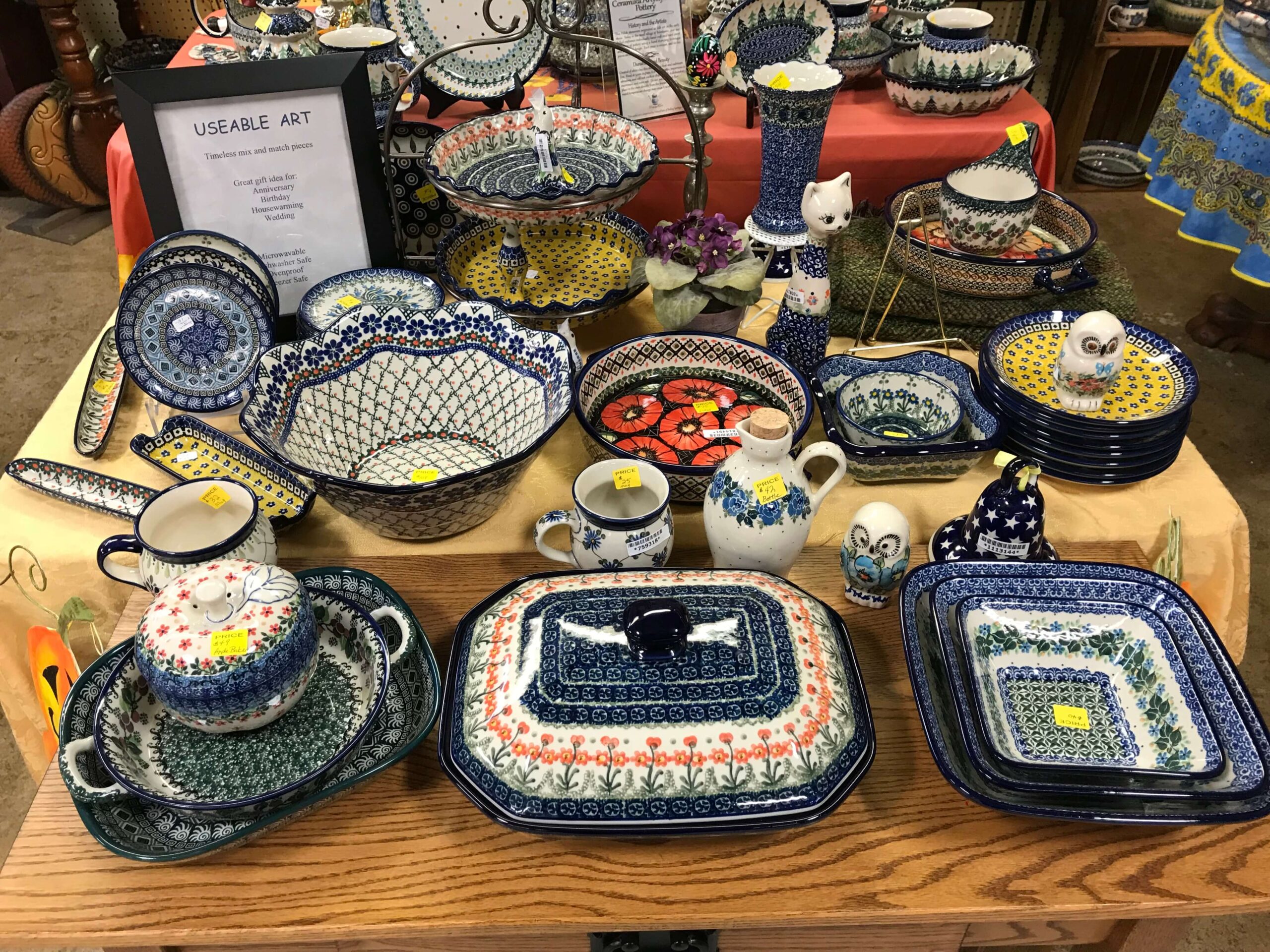 Colorful patterned stoneware on display on a table at a farmer's market