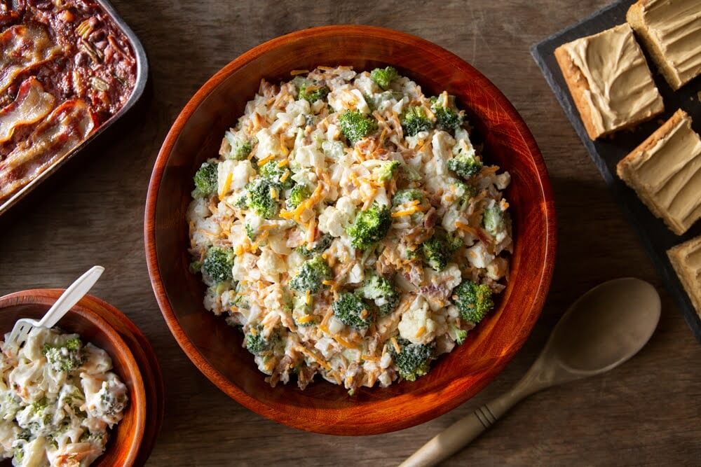 bowl of freshly prepared amish broccoli salad sitting on the countertop