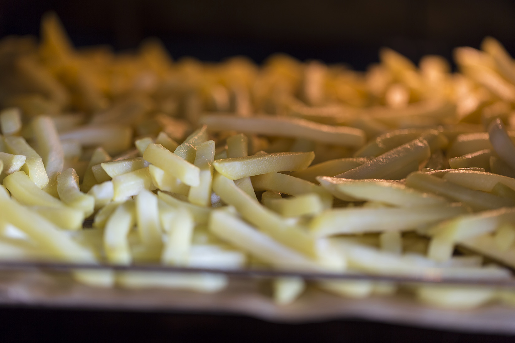 tray of french fries baking in the oven