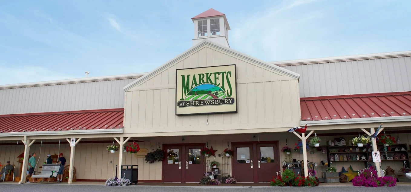 Exterior of Markets at Shrewsbury building with hanging plants and flowers.
