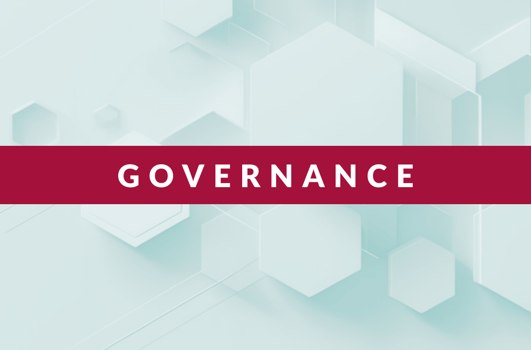 Word ‘GOVERNANCE’ in white capital letters on a horizontal maroon banner over a light blue hexagonal pattern background.