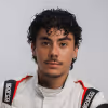 Bryce Rodriguez - Portrait of a young man with curly dark hair wearing a white racing suit with red and black accents.