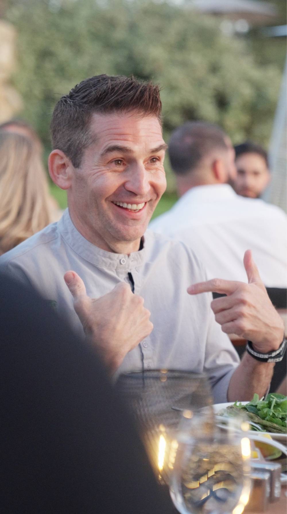 Todd Dunphy in conversation at an outdoor dinner