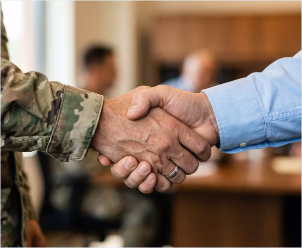 IES team member shaking hands with a service member in uniform