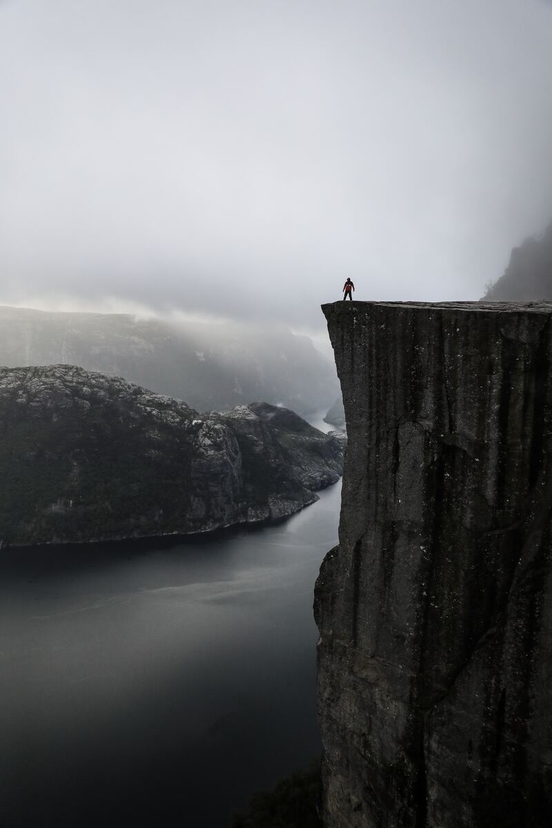 a person standing on the edge of a cliff