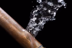 water leaks out of cracked copper water line