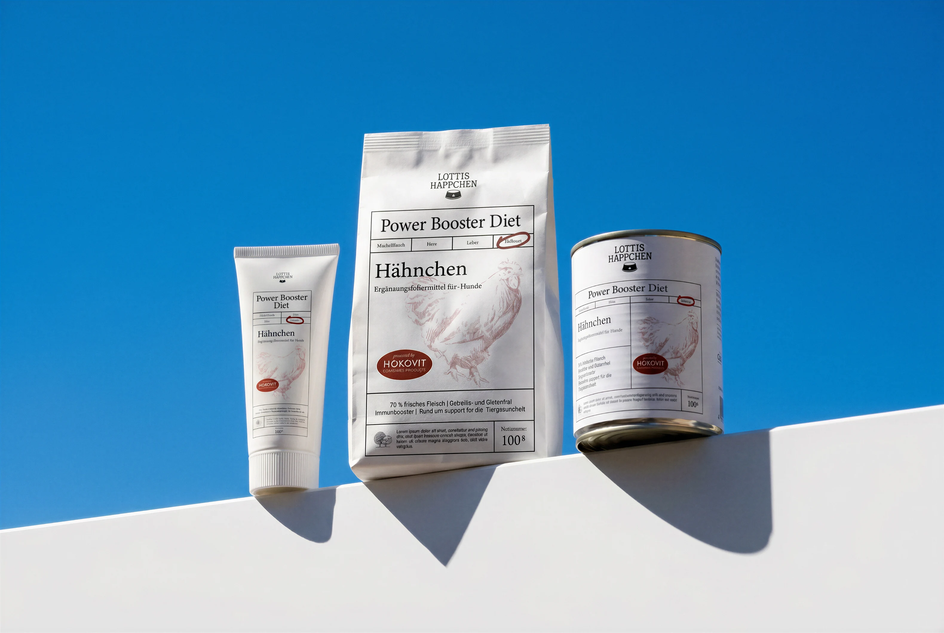 Three Lottis Happchen Power Booster Snack packages against blue sky on white surface.