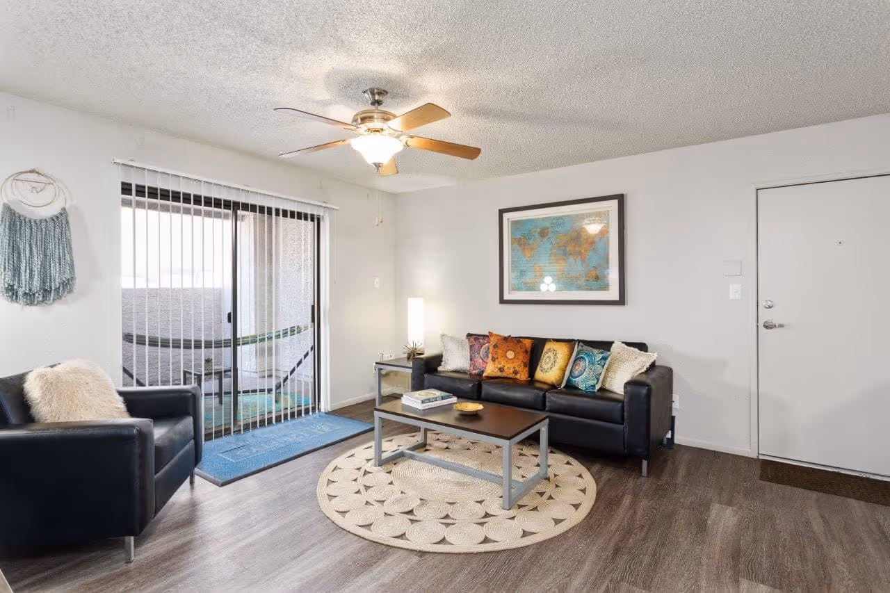 Living area with sofa, rug, and patio doors